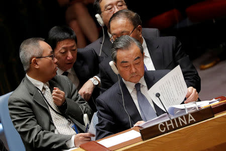 China's Foreign Minister Wang Yi and the Chinese delegation listen to U.S. President Donald Trump address the U.N. Security Council meeting at the 73rd session of the United Nations General Assembly at U.N. headquarters in New York, U.S., September 26, 2018. REUTERS/Carlos Barria