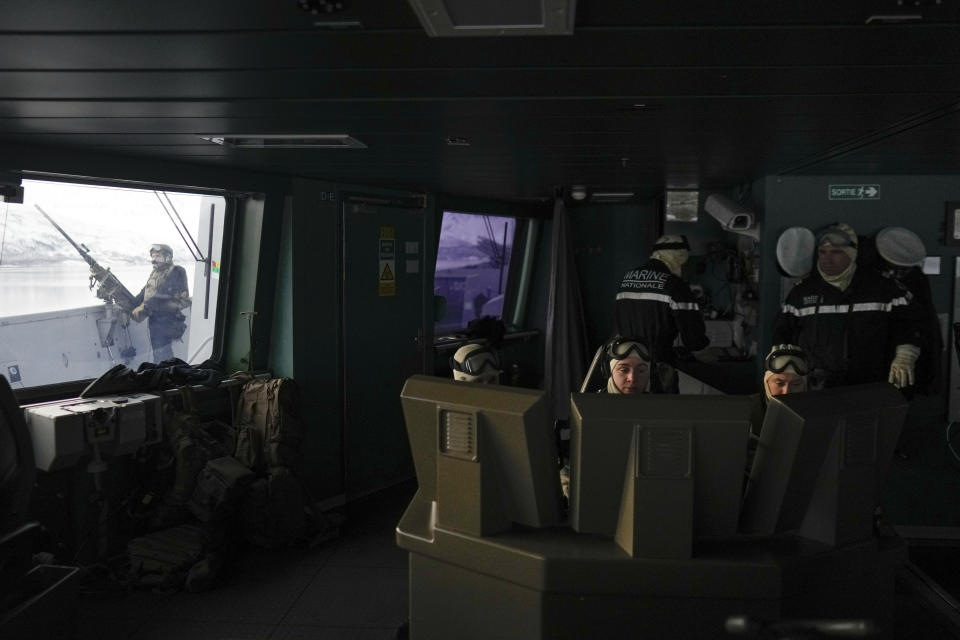 French sailors on the bridge of the French navy frigate Normandie keep watch as the vessel patrols in a Norwegian fjord, north of the Arctic circle, for a reconnaissance patrol, Wednesday March 6, 2024. The French frigate is part of a NATO force conducting exercices in the seas, north of Norway, codenamed Steadfast Defender, which are the largest conducted by the 31 nation military alliance since the cold war. (AP Photo/Thibault Camus)