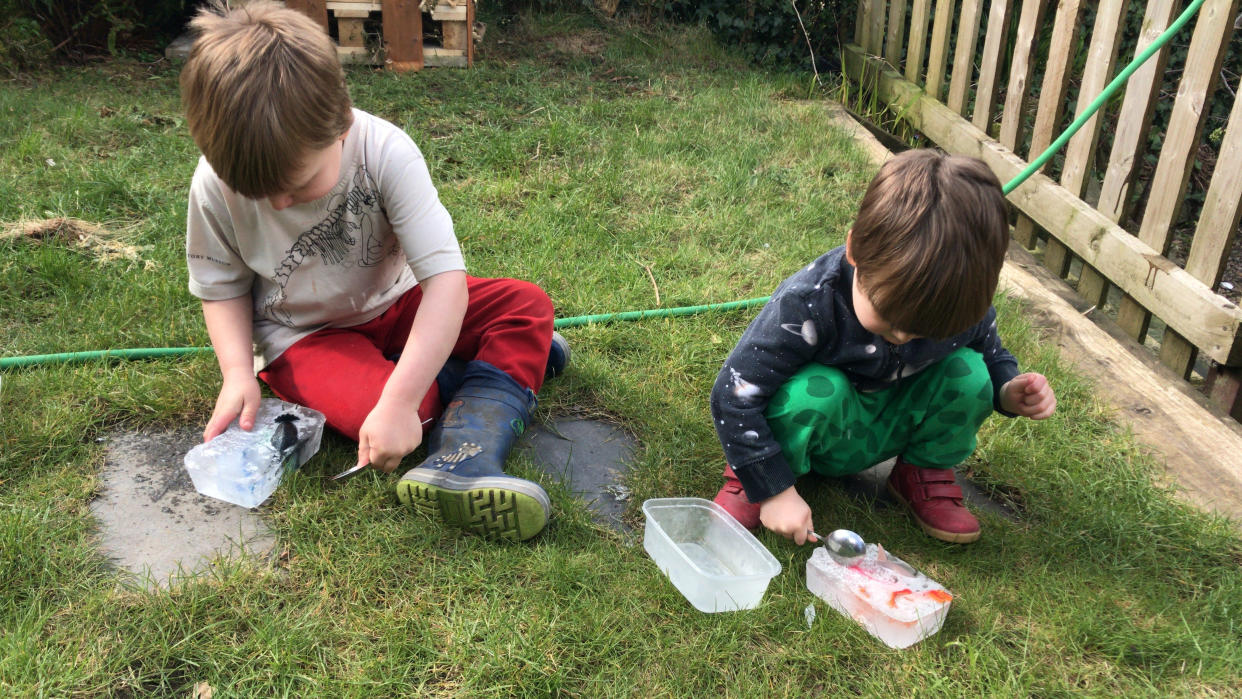 Two U.K. boys had to rescue their toys from ice thanks to their dad's clever parenting hack. (Photo: SWNS)