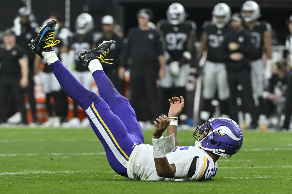 Minnesota Vikings quarterback Joshua Dobbs (15) falls after the throw during the second half of an NFL football game against the Las Vegas Raiders, Sunday, Dec. 10, 2023, in Las Vegas. (AP Photo/David Becker)