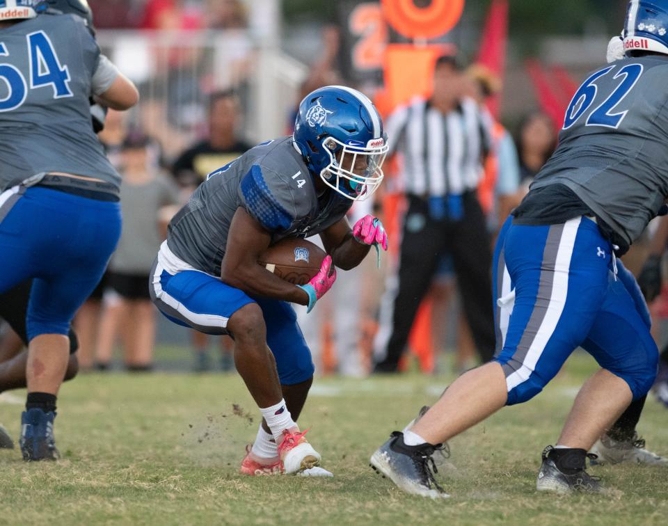 James Brown (14) carries the ball during the West Florida vs Washington football game at Booker T. Washington High School in Pensacola on Friday, Sept. 2, 2022.