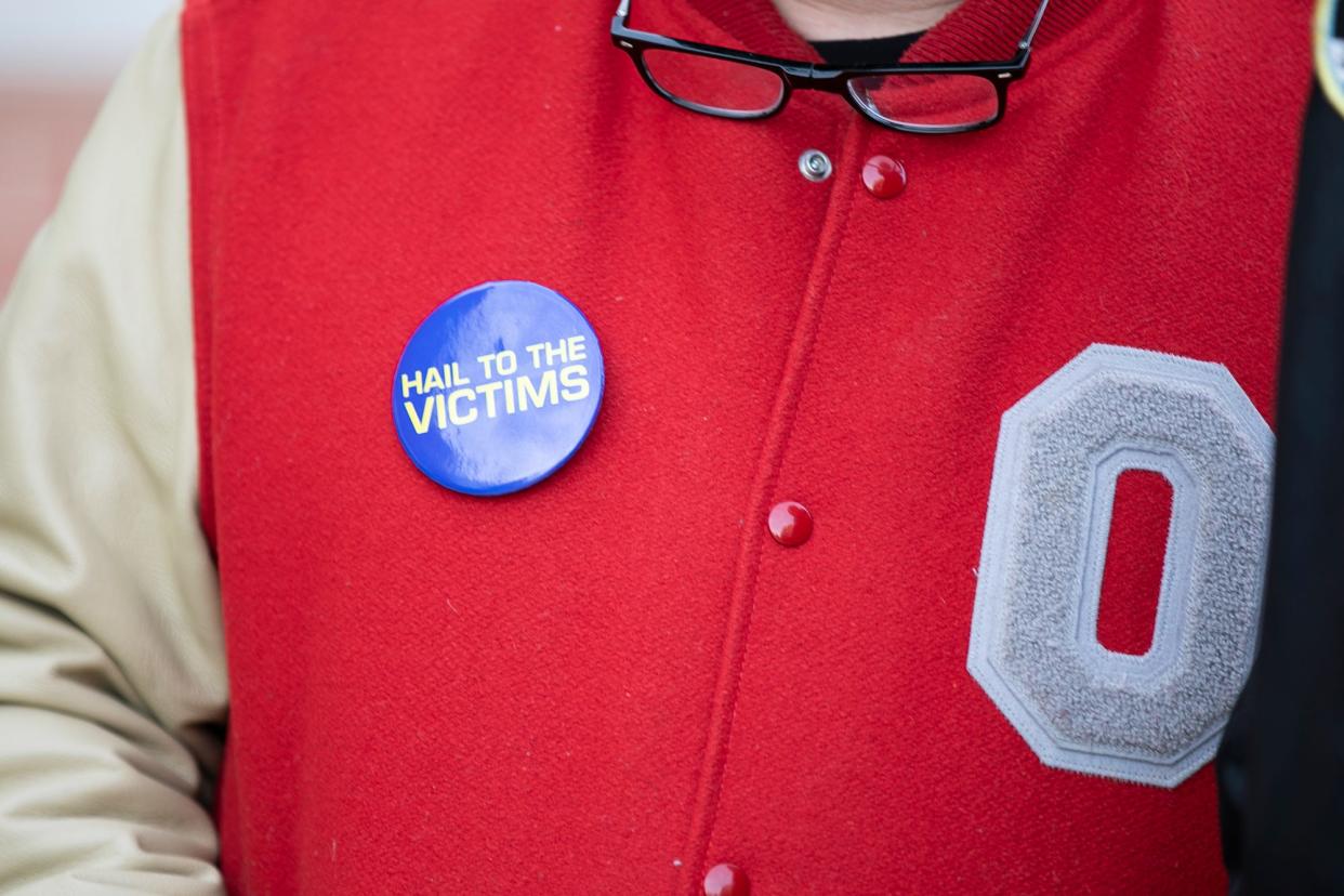 Survivors and supporters gather as three former Ohio State athletes - Steve Snyder-Hill, Gary Avis and a John Doe - who said they were sexually abused by university physician Richard Strauss decades ago addressed Ohio State's Board of Trustees in November 2021, calling on the university to "tell the truth" and "do the right thing."