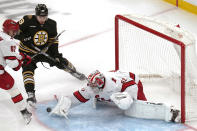 Carolina Hurricanes goaltender Pyotr Kochetkov (52) makes the save as Boston Bruins center John Beecher (19) watches the puck during the third period of an NHL hockey game, Tuesday, April 9, 2024, in Boston. (AP Photo/Charles Krupa)