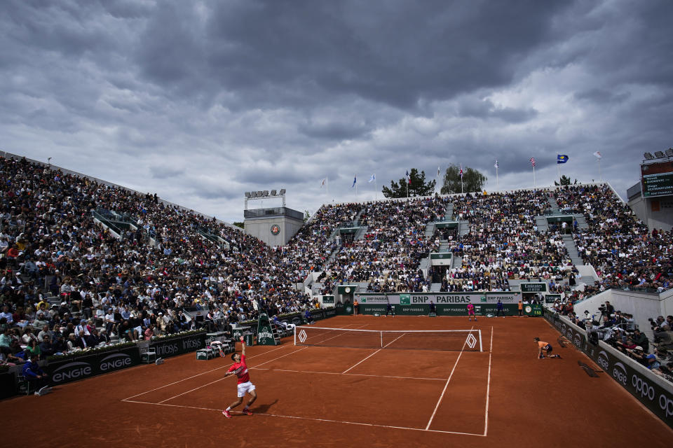 Serbia's Novak Djokovic, foreground, serves against Argentina's Diego Schwartzman during their fourth round match at the French Open tennis tournament in Roland Garros stadium in Paris, France, Sunday, May 29, 2022. (AP Photo/Christophe Ena)