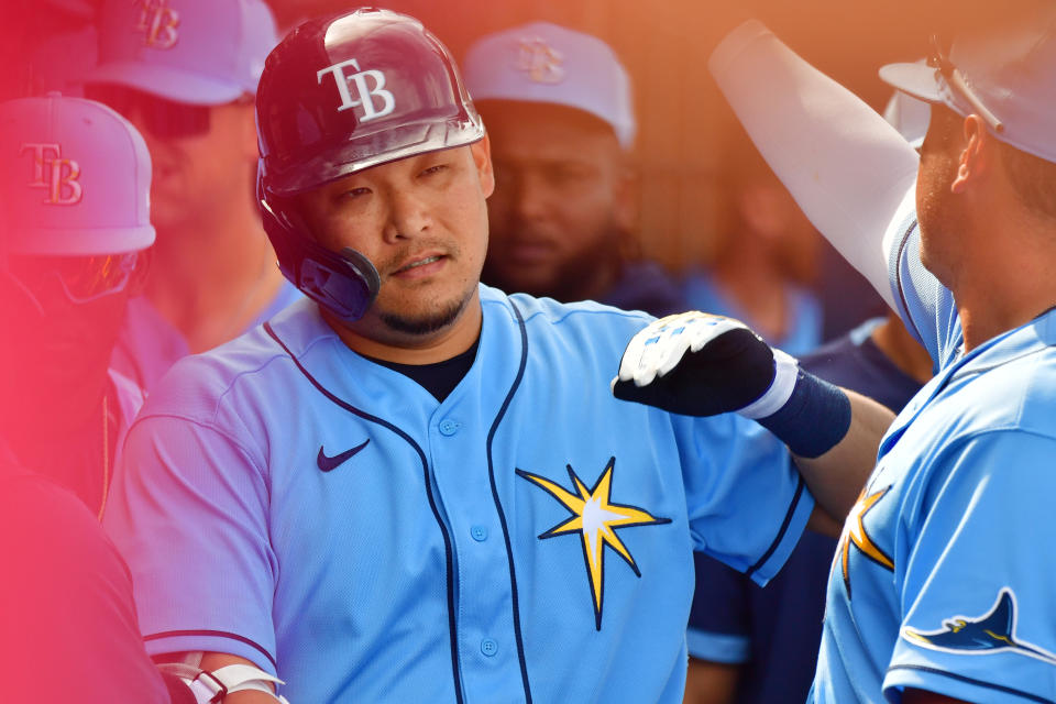 PORT CHARLOTTE, FLORIDA - FEBRUARY 24: Yoshitomo Tsutsugo #25 of the Tampa Bay Rays high fives teammates after hitting his first home run in the majors in the fourth inning against the Boston Red Sox at Charlotte Sports Park on February 24, 2020 in Port Charlotte, Florida. (Photo by Julio Aguilar/Getty Images)