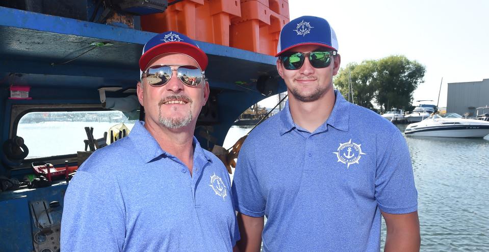 Jim Shaffer, left, owner of Strong Winds Fisheries and Presque Isle Fish & Farm, is shown with son Wyatt Shaffer on board the Dixie, docked just east of State Street in Erie.