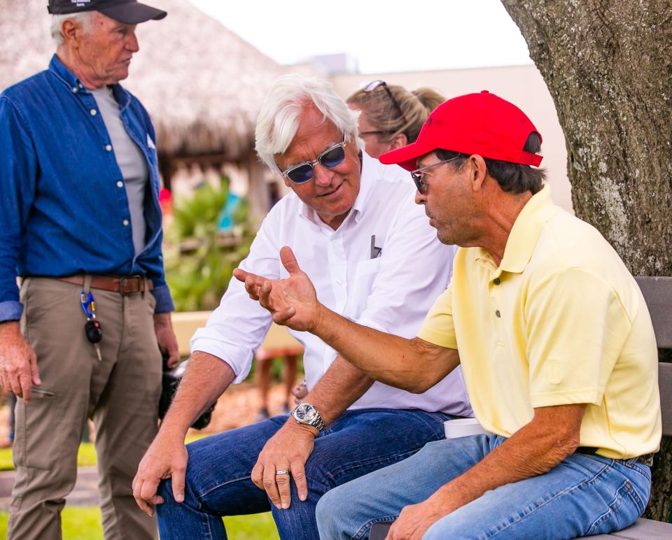 Horse Trainer Bob Baffert, center, talks with breeze rider Gonzalo Guevara, right, while at the Ocala Breeders' Sales Company's 2022 Spring Sale of Two-Year-Olds in Training on Wednesday.