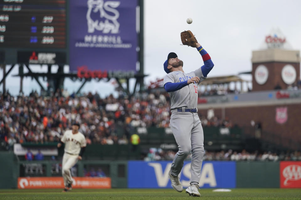 Chicago Cubs third baseman Patrick Wisdom catches a ball hit by San Francisco Giants' Brandon Belt for the out during the first inning of a baseball game in San Francisco, Saturday, July 30, 2022. (AP Photo/Godofredo A. Vásquez)