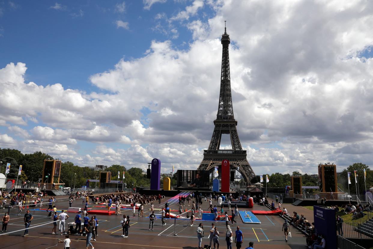 Visitors walk in the fan village of the Trocadero, in front of the Eiffel Tower, on August 1, 2021. (Photo by GEOFFROY VAN DER HASSELT / AFP) (Photo by GEOFFROY VAN DER HASSELT/AFP via Getty Images)