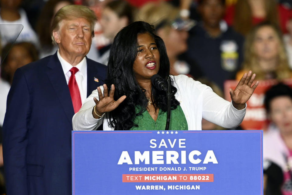 FILE - Former President Donald Trump, left, listens as Michigan Republican secretary of state candidate Kristina Karamo speaks during a rally at the Macomb Community College Sports & Expo Center in Warren, Mich., Oct. 1, 2022. Campaign spending in races to oversee state election is setting new records. It's been spurred by candidates who echo Trump's lies about fraud costing him the 2020 presidential election. Trump is backing many of these candidates to take top elections posts in critical swing states. (Todd McInturf/Detroit News via AP, File)