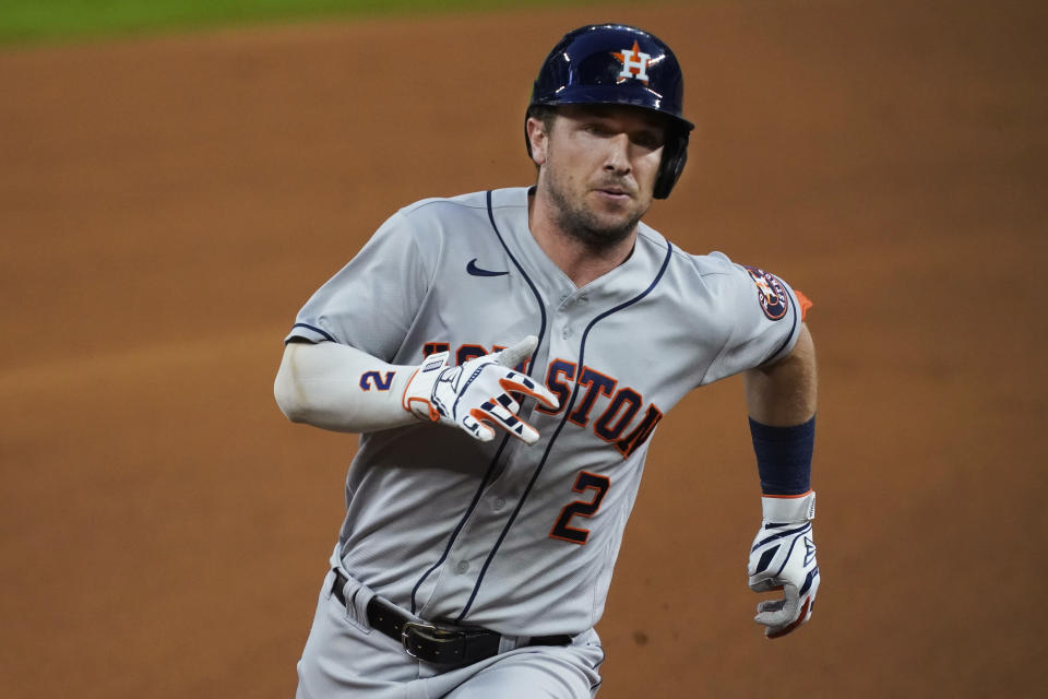 Houston Astros' Alex Bregman heads to third with a triple during the first inning of the team's baseball game against the Texas Rangers in Arlington, Texas, Thursday, Sept. 24, 2020. (AP Photo/Tony Gutierrez)