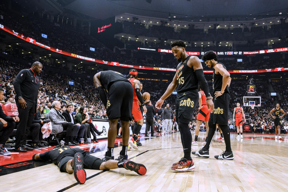 Cleveland Cavaliers guard Darius Garland (10) lies on the floor after being injured during the first half of the team's NBA basketball game against the Toronto Raptors on Wednesday, Oct. 19, 2022, in Toronto. (Christopher Katsarov/The Canadian Press via AP)
