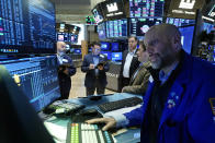 Traders gather at the post that handles Brazilian mining company Vale, with specialist Meric Greenbaum, right, on the floor of the New York Stock Exchange, Monday, Nov. 29, 2021. Wall Street is steadying itself Monday from last week's slide caused by the newest coronavirus variant, as investors wait for more clues about just how much damage it may do to the economy. (AP Photo/Richard Drew)