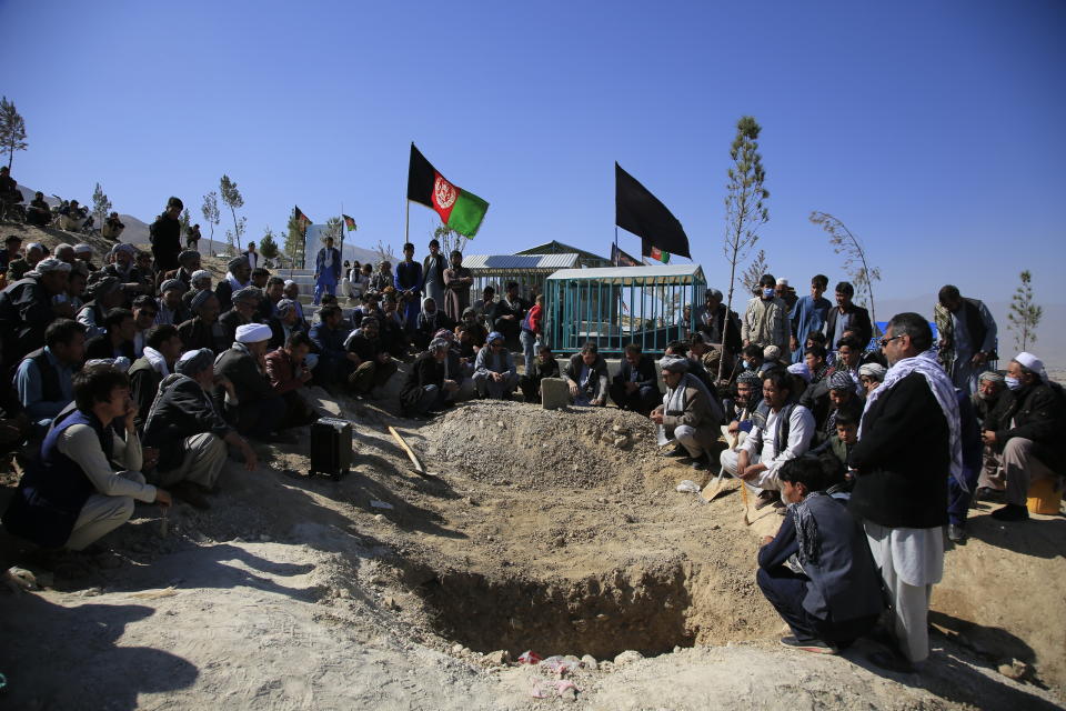 FILE - in this Oct. 25, 2020 file photo, Afghan men bury a victim of a suicide attack that targeted an education center, in Kabul Afghanistan. The U.N. says the number of civilians killed and wounded in Afghanistan fell by 15% last year, compared to 2019. A report released Tuesday, Feb.23, 2021, attributed the drop in civilian casualties in part to an apparent tactical change by insurgents to targeted killings, fewer suicide bombings, and a stark drop in casualties attributed to international military forces. (AP Photo/Mariam Zuhaib, File)