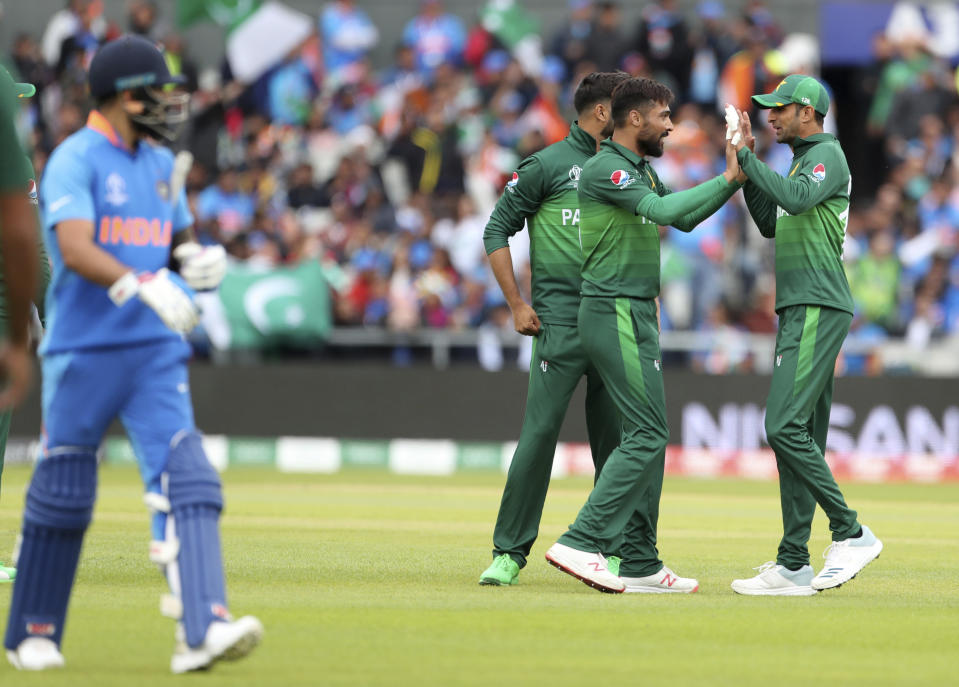 Pakistan's Mohammad Amir, second right, celebrates with teammates the dismissal of India's captain Virat Kohli, left, during the Cricket World Cup match between India and Pakistan at Old Trafford in Manchester, England, Sunday, June 16, 2019. (AP Photo/Aijaz Rahi)