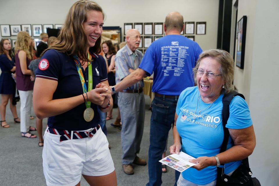 Harrison and Purdue graduate and 2016 Olympic gold medalist Amanda Elmore shares a laugh with her former gymnastics coach Betty Bolyard-Schnepp Thursday, September 8, 2016, during a reception in Elmore's honor at the Purdue Boathouse, 500 Brown Street in West Lafayette. Elmore called her selection to the team a "dream come true."