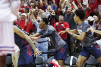 Dayton players and fans celebrate after their upset win over Kansas at the end of an NCAA college basketball game Friday, Nov. 26, 2021, in Lake Buena Vista, Fla. (AP Photo/Jacob M. Langston)