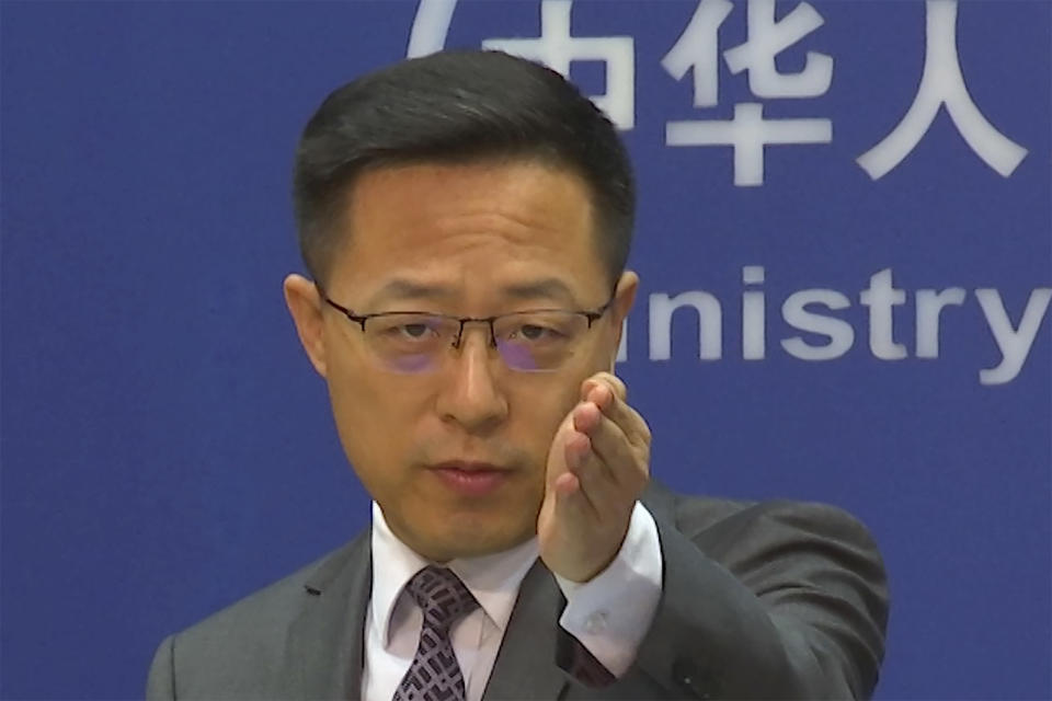 Chinese Foreign Ministry spokesperson Zhao Lijian gestures during a news conference at the Ministry of Foreign Affairs in Beijing, Wednesday, July 27, 2022. China's government on Wednesday rejected as a "political lie" a report by The Wall Street Journal that Beijing tried to recruit informants in the Federal Reserve system to obtain U.S. economic data. (AP Photo/Liu Zheng)
