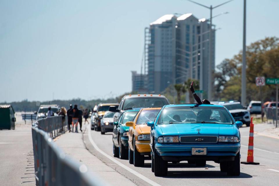 A spring breaker takes a photo from his car as he sits in traffic along Highway 90 during Black Spring Break in Biloxi on Saturday, April 9, 2022.