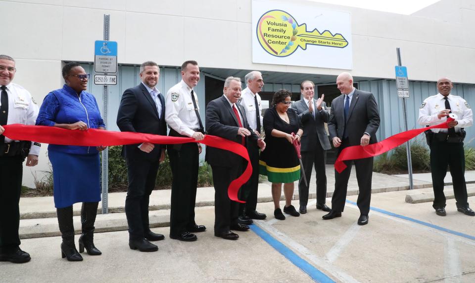 Volusia County Sheriff Office Juvenile Services Director Carla Quann cuts the ribbon for the Volusia Family Resource Center, Thursday, Nov. 17, 2022, with officials.