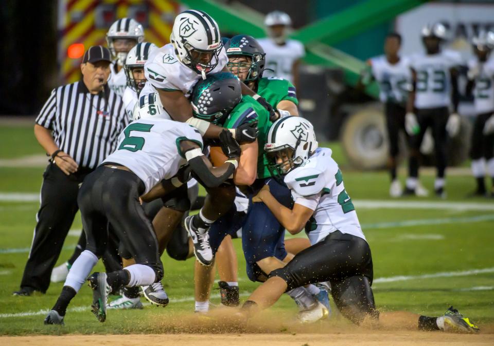 The Richwoods defense brings down Peoria Notre Dame's Liam Ludolph in the first half Friday, Sept. 16, 2022 at Dozer Park.