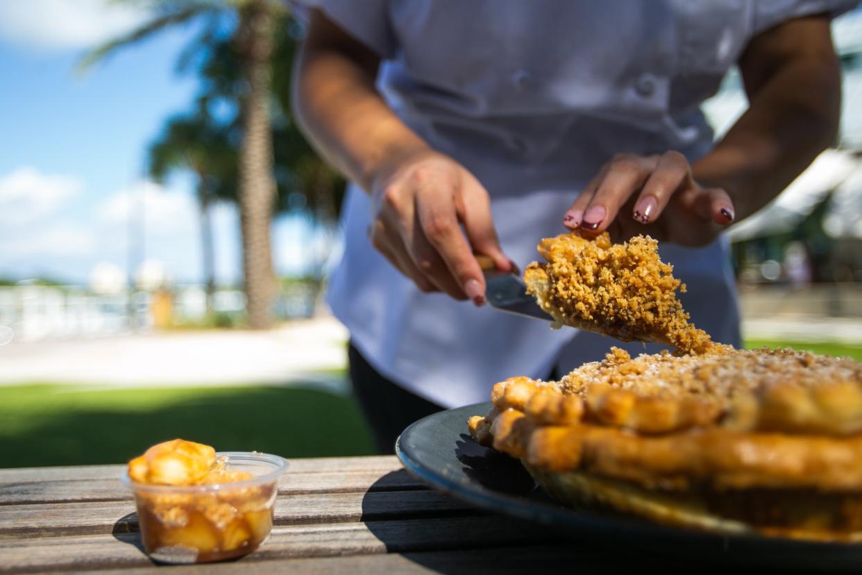 Executive pastry chef Jennifer Woo of the Charlie and Joe's at Love Street restaurants in Jupiter slices a Dutch apple pie, one of the Thanksgiving creations she is making for Pie It Forward.