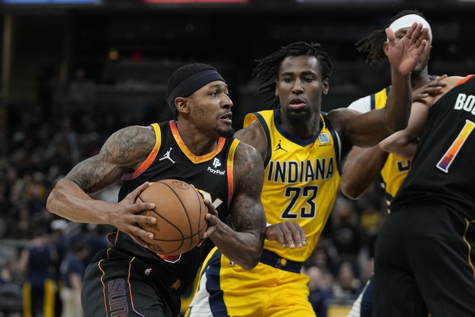 Phoenix Suns' Bradley Beal (3) goes to the basket against Indiana Pacers' Aaron Nesmith (23) during the first half of an NBA basketball game, Friday, Jan. 26, 2024, in Indianapolis. (AP Photo/Darron Cummings)