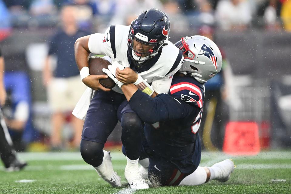 New England Patriots defensive tackle Daniel Ekuale sacks Houston Texans quarterback C.J. Stroud.