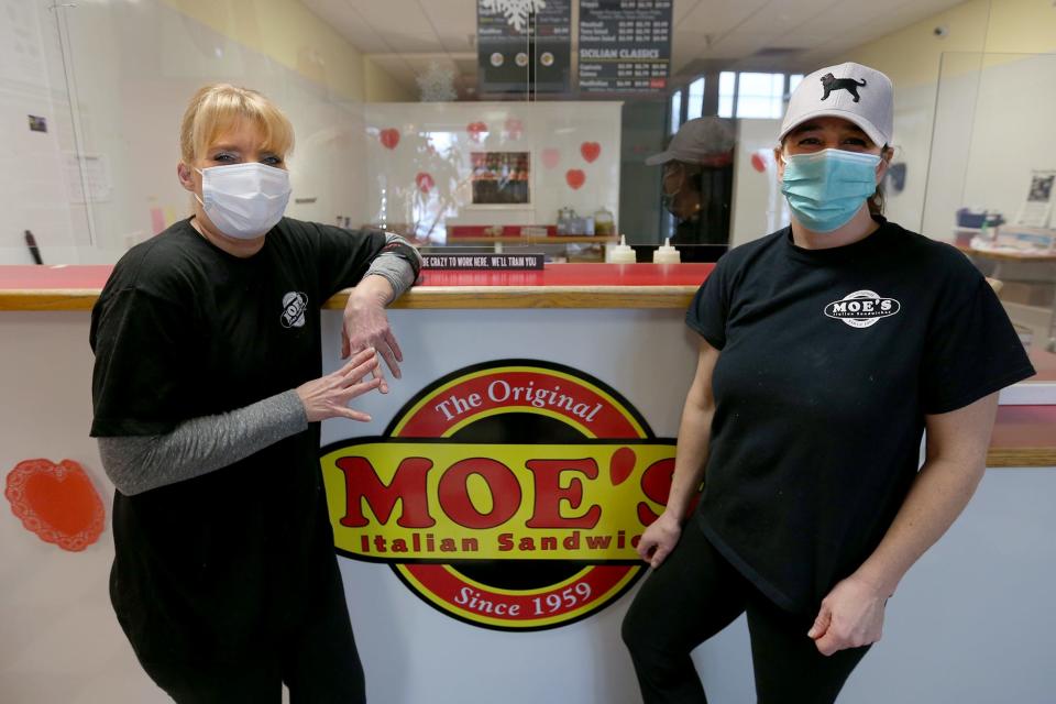 From left, Meredith Stamnas and Patti O’Leary make sandwiches for the lunch rush on Feb. 1, 2022, at the Moe’s Italian Sandwiches in Exeter.