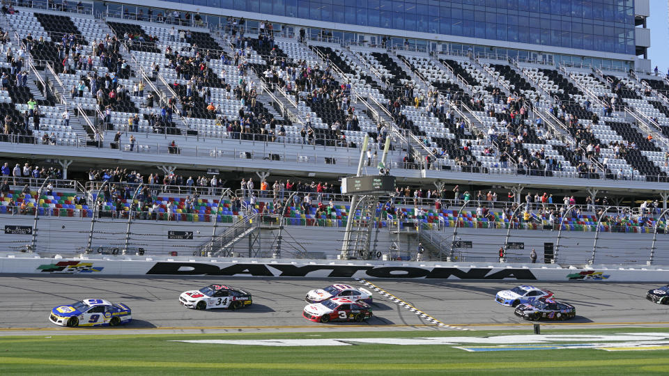 Chase Elliott (9), Michael McDowell (34), Austin Dillon (3), and Denny Hamlin (11) lead the field to start the NASCAR Cup Series road-course auto race at Daytona International Speedway, Sunday, Feb. 21, 2021, in Daytona Beach, Fla. (AP Photo/John Raoux)