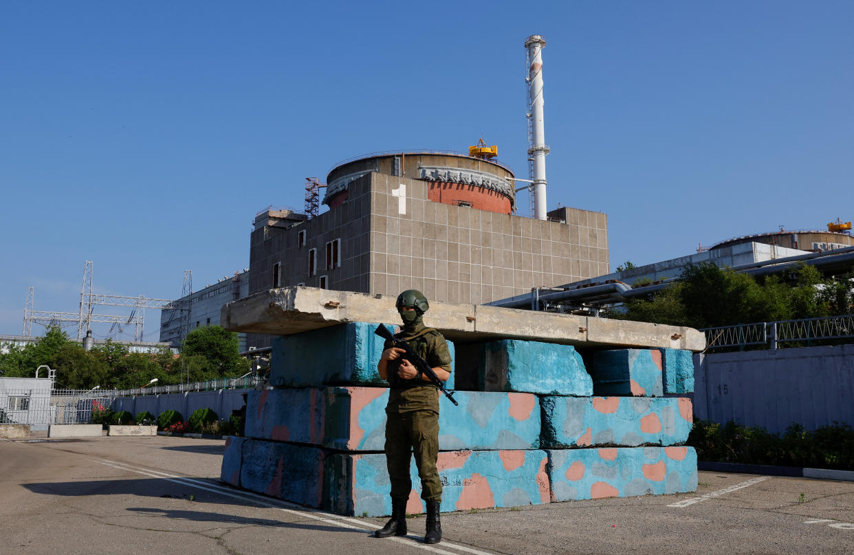 A Russian service member stands guard at a checkpoint near the Zaporizhzhia Nuclear Power Plant before the arrival of the International Atomic Energy Agency (IAEA) expert mission in the course of Russia-Ukraine conflict outside Enerhodar in the Zaporizhzhia region, Russian-controlled Ukraine, June 15, 2023. REUTERS/Alexander Ermochenko