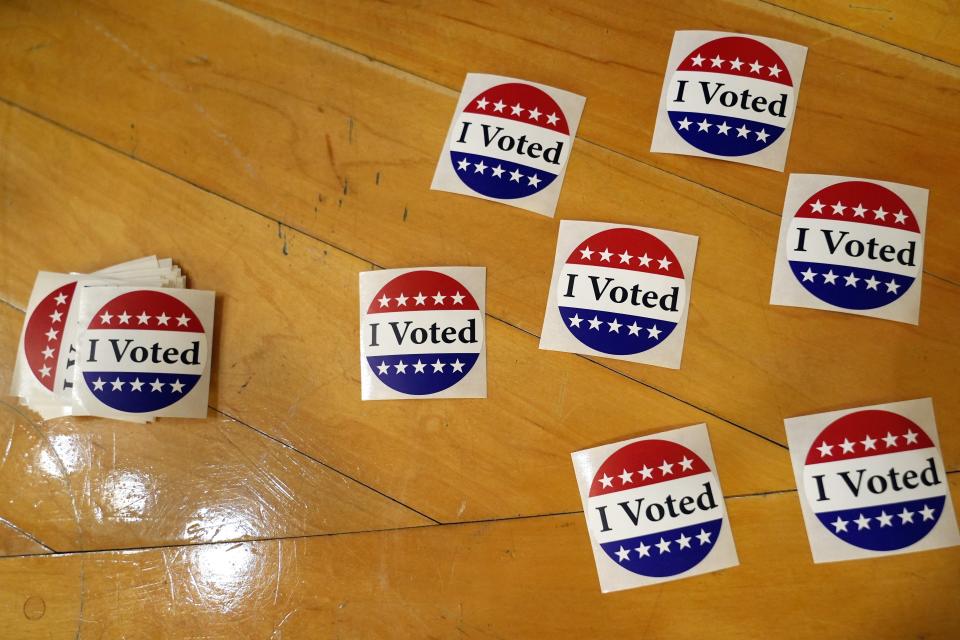 Stickers are laid out at the exit to the polling station in Kennebunk, Maine, Tuesday, March 5, 2024. Super Tuesday elections are being held in 16 states and one territory. Hundreds of delegates are at stake, the biggest haul for either party on a single day. (AP Photo/Michael Dwyer)