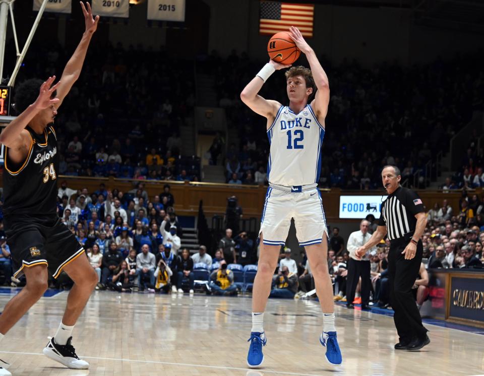 Duke forward TJ Power shoots a 3-pointer as La Salle guard Tunde Vahlberg Fasasi defends during the second half at Cameron Indoor Stadium.