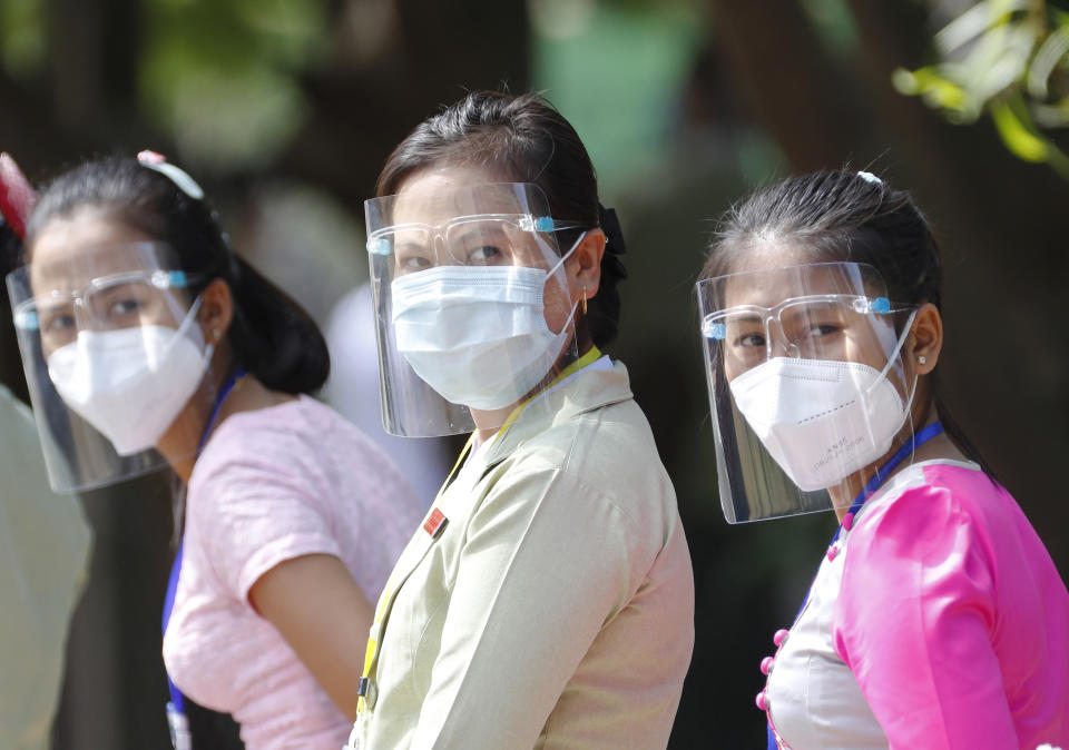 Participants wearing protective face mask and shield stand as they take part in a demonstration of the voting for upcoming Nov.8 general election, Tuesday, Oct. 20, 2020, in Naypyitaw, Myanmar. (AP Photo/Aung Shine Oo)