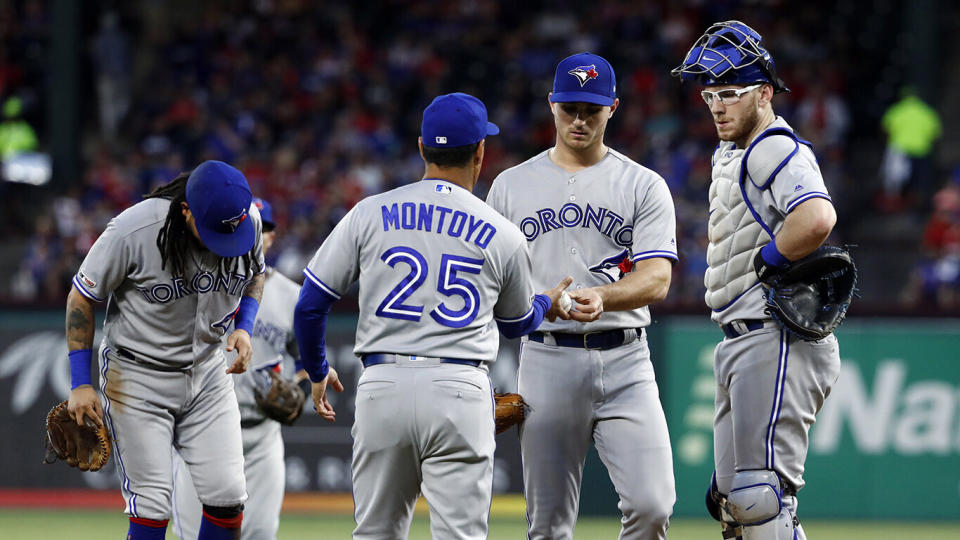 Toronto Blue Jays manager Charlie Montoyo (25) takes the ball from relief pitcher Thomas Pannone, center, right. (AP Photo/Tony Gutierrez)