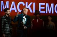 Winners For Best New Artist Macklemore (C) and Ryan Lewis accept their trophy on stage during the 56th Grammy Awards at the Staples Center in Los Angeles, California, January 26, 2014