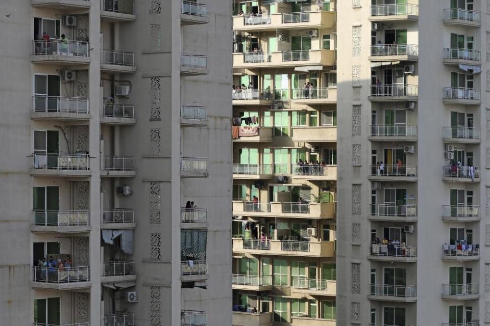 People clap and bang utensils from their balconies