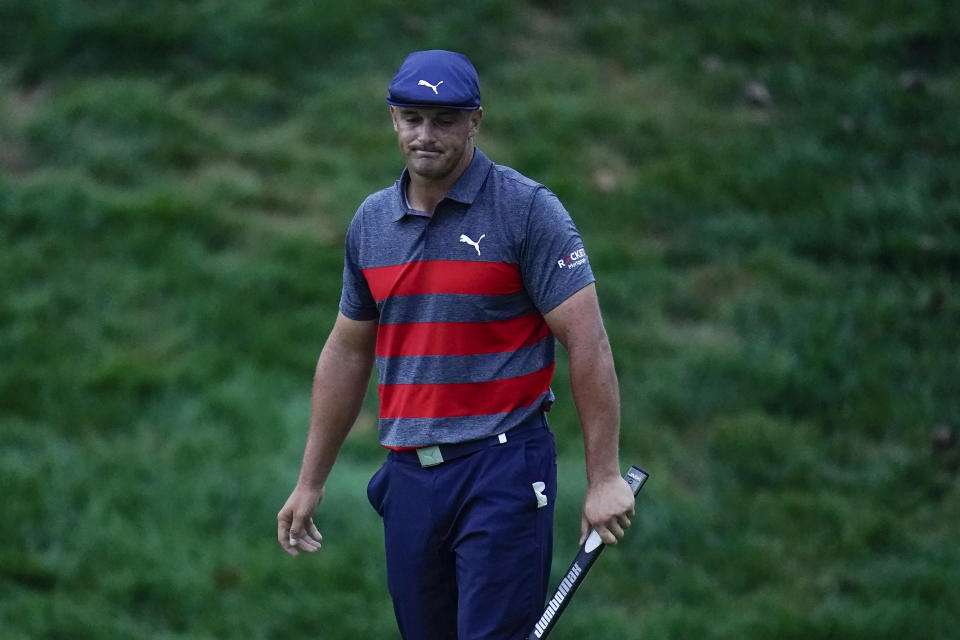 Bryson DeChambeau reacts after missing a putt on the 18th green, the sixth playoff hole during the final round of the BMW Championship golf tournament, to give Patrick Cantlay the victory, Sunday, Aug. 29, 2021, at Caves Valley Golf Club in Owings Mills, Md. (AP Photo/Julio Cortez)