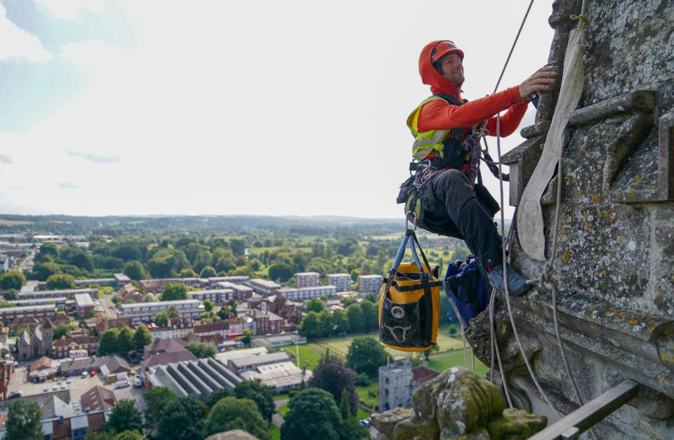 <p>A rope access conservator from Vitruvius Building Conservartion, abseils down the East face of Salisbury Cathedral's Tower to carry out vital repairs and surveying during their annual inspection. Picture date: Tuesday August 24, 2021.</p>
