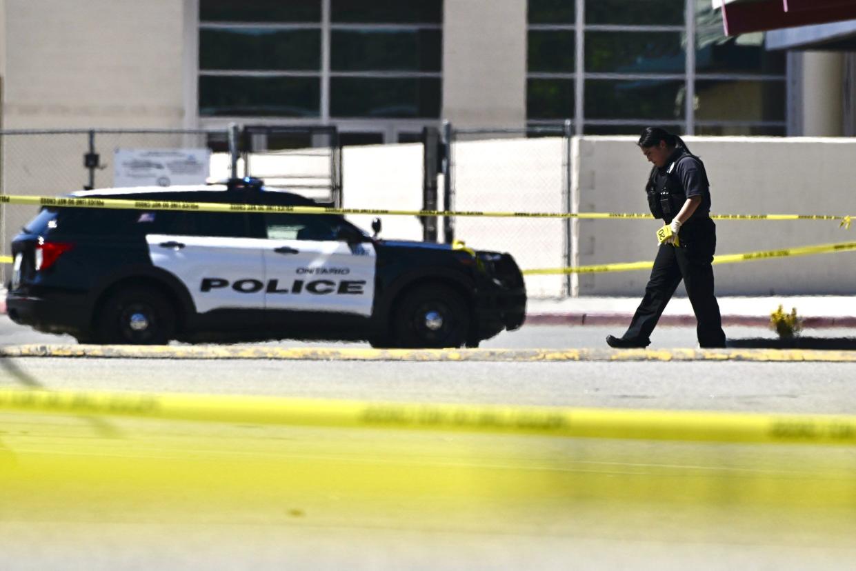 A police officer marks the scene of a shooting in Ontario, Calif., on Saturday after a person was shot several times at a youth football game at Colony High School. The game was not a school-sponsored event.