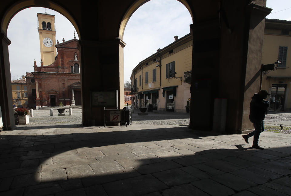 In this photo taken on Thursday, March 12, 2020, a man walks in Codogno, Italy. The northern Italian town that recorded Italy’s first coronavirus infection has offered a virtuous example to fellow Italians, now facing an unprecedented nationwide lockdown, that by staying home, trends can reverse. Infections of the new virus have not stopped in Codogno, which still has registered the most of any of the 10 Lombardy towns Italy’s original red zone, but they have slowed. For most people, the new coronavirus causes only mild or moderate symptoms. For some it can cause more severe illness. (AP Photo/Antonio Calanni)