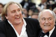 French actor Gerard Depardieu (L) arrives with FIFA President Sepp Blatter for the screening of the film "United Passions" at the 67th edition of the Cannes Film Festival in Cannes, southern France, on May 18, 2014. AFP PHOTO / VALERY HACHE (Photo credit should read VALERY HACHE/AFP via Getty Images)