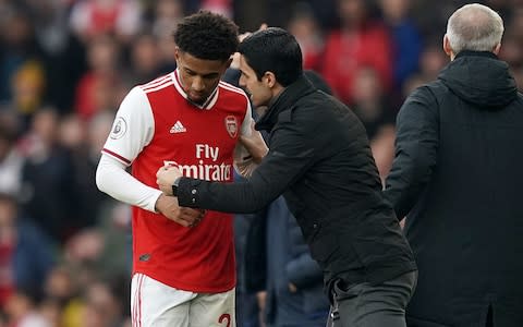 Arsenal manager Mikel Arteta (right) gives intructions to Reiss Nelson from the touchline during the Premier League match at The Emirates Stadium - Credit: PA