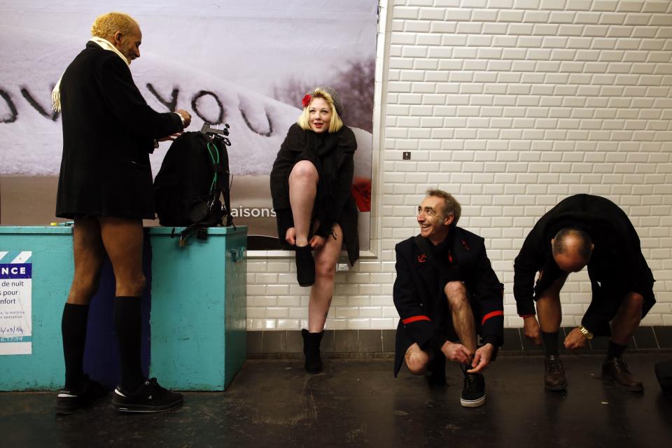 Passengers without their pants wait for a train during the "No Pants Subway Ride" event at a subway station in Paris