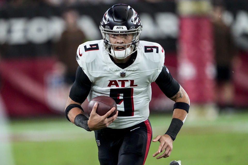 Atlanta Falcons quarterback Desmond Ridder (9) runs out of the pocket against the Arizona Cardinals during the second half of an NFL football game, Sunday, Nov. 12, 2023, in Glendale, Ariz. (AP Photo/Matt York)