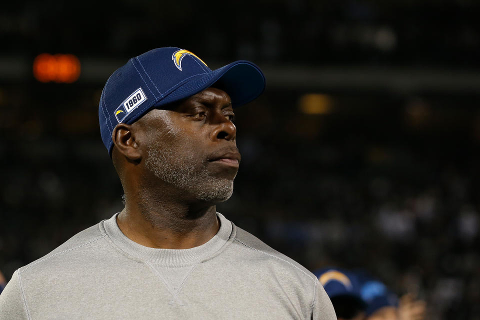 Anthony Lynn stares at a football game. 