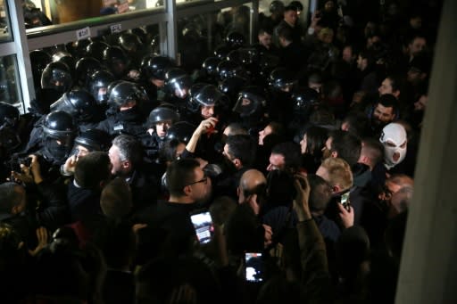 Serbian riot police clash with protesters at the state-run TV headquarters in Belgrade last Saturday