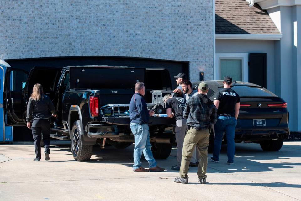 Drug Enforcement Administration agents and other law enforcement officers search two cars as a part of raids conducted on the home of Biloxi Councilman Robert Deming III on Thursday, Jan. 26, 2023. Agents would not say specifically what they were looking for or what they found, but agents also conducted raids on several locations of The Candy Shop & Kratom, a kratom store chain owned by Deming.