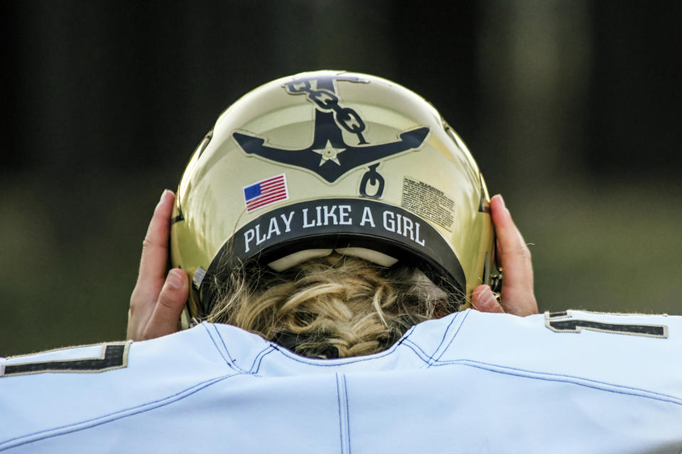 In this image provided by Vanderbilt Athletics, Vanderbilt kicker Sarah Fuller adjusts her helmet during NCAA college football practice, Wednesday, Nov. 25, 2020, in Nashville, Tenn. Fuller, a goalkeeper on the Commodores' women's soccer team, will don a football uniform on Vanderbilt's sideline and she is poised to become the first woman to play in a Power 5 game when the Commodores take on Missouri. (Vanderbilt Athletics via AP)