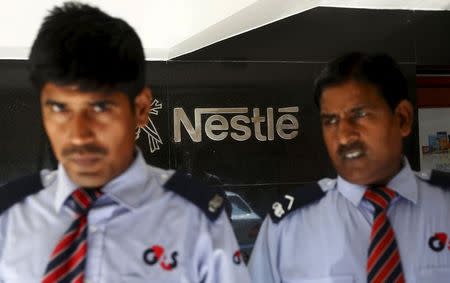 Security guards stand guard outside a corporate office of Nestle India Ltd. in New Delhi, India, June 8, 2015. REUTERS/Adnan Abidi